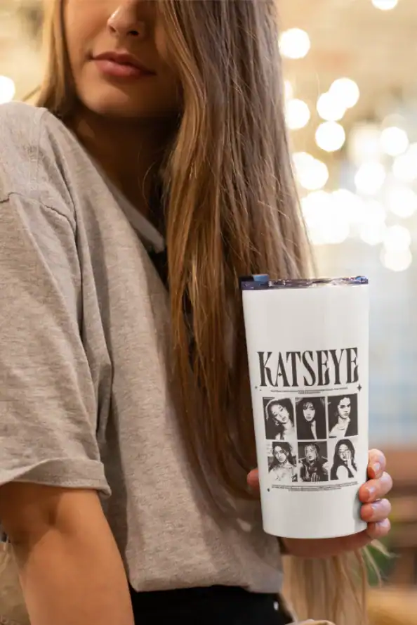 model holding white katseye bottle with band members design